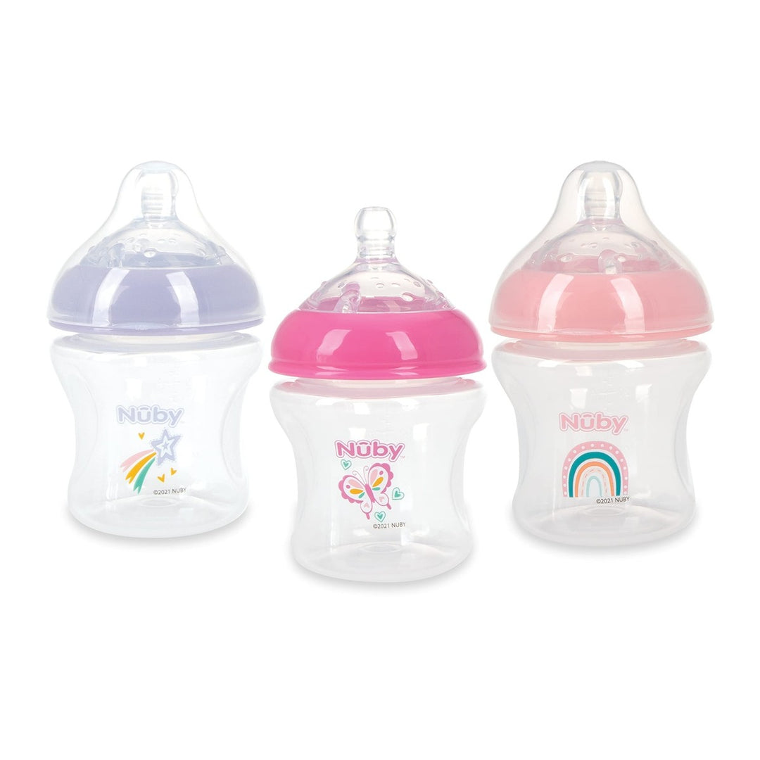 Three Nuby baby bottles with colored lids and cute designs for infants and newborn feeding