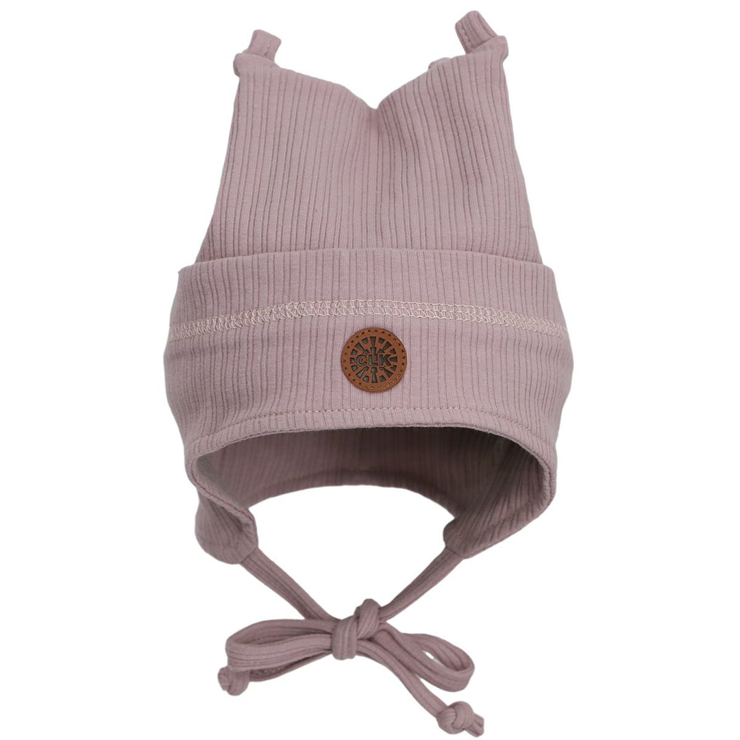 Lilac ribbed baby hat with ear flaps, tie straps, and faux leather patch detail