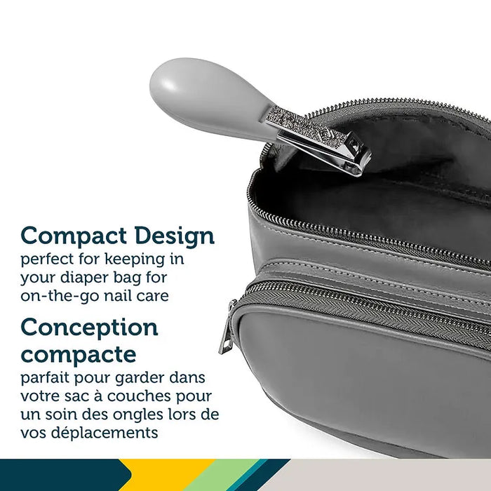 Compact nail clipper with grey handle placed in an open diaper bag, ideal for baby nail care.