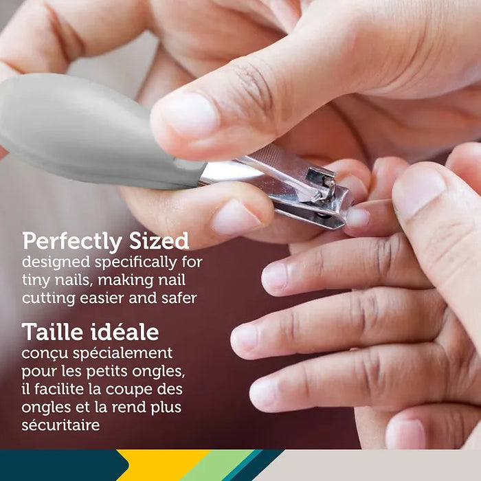 Adult using gray baby nail clippers to trim child's fingernails, close-up.
