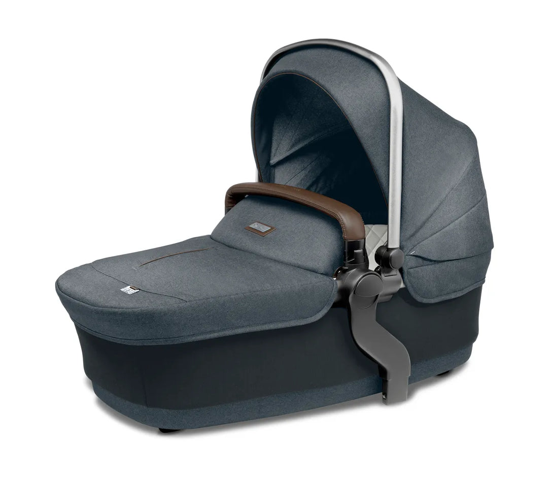 Slate grey baby bassinet with canopy and leather handle, ideal for stroller use