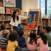 Solid maple wood large book easel at the library during story time with children listening