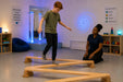 solid maple wooden balance board for kids - Kid in a sensory room at school with the special educator observing