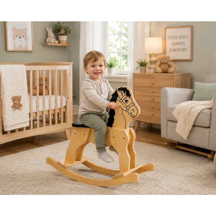 Solid durable maple wood classic rocking horse toy in a nursery with a little boy sitting on the horse smiling - Goldtex
