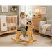 Solid durable maple wood classic rocking horse toy in a nursery with a little boy sitting on the horse smiling - Goldtex