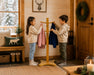 Solide maple wooden coat rack for kids with 2 children hanging their coats at the cottage