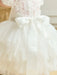 Warm Wendy Off-White Lace Baptism Dress shown from the back with tulle skirt and satin bow.