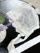 Teter Warm 3D floral detailing baby bonnet with lace and ribbon, displayed on a black surface.
