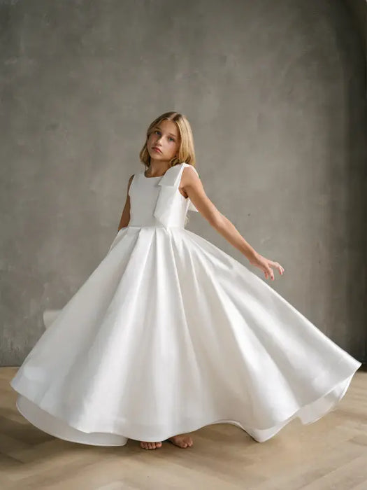 Teter Warm Addison Satin Bow Shoulder Communion Dress worn by a girl standing indoors.