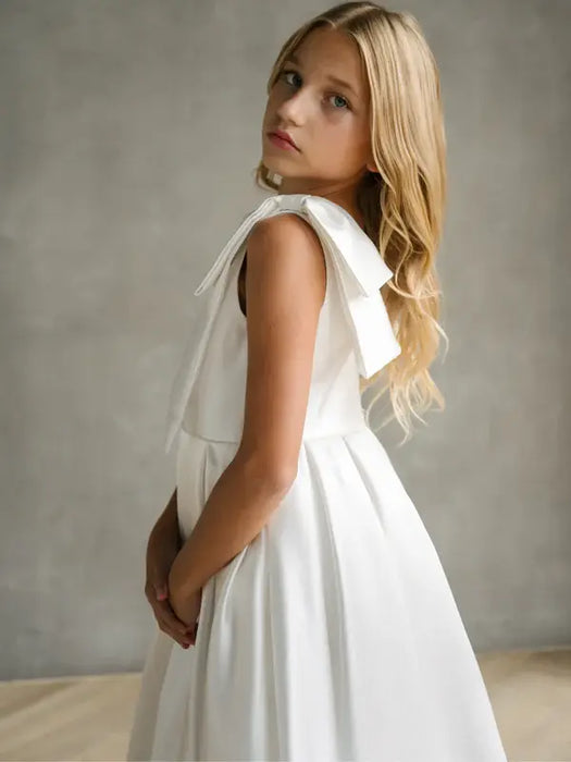Teter Warm Addison Satin Bow Shoulder Communion Dress shown on a girl standing indoors