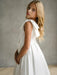 Teter Warm Addison Satin Bow Shoulder Communion Dress shown on a girl standing indoors