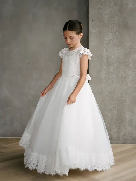 Teter Warm Ariana Lace Communion Dress shown on a young girl standing indoors on wood floor