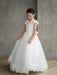 Teter Warm Ariana Lace Communion Dress shown on a young girl standing indoors on wood floor