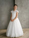 Teter Warm Ariana Lace Communion Dress shown on a girl standing indoors against a gray background.