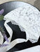 Teter Warm Bold Floral Bay Bonnet featuring white lace with ribbon ties, displayed on a table.