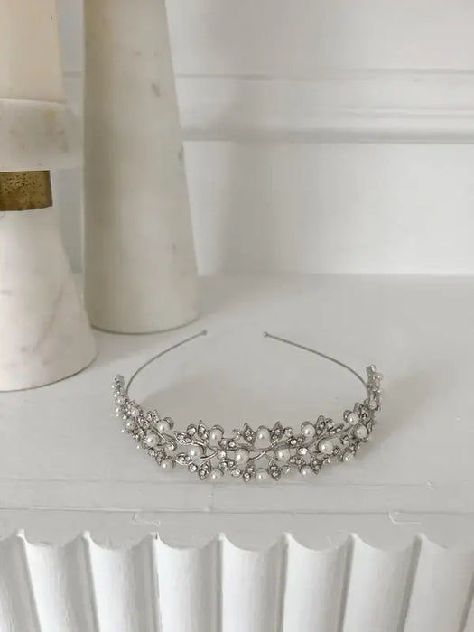 Cecilia rhinestone headpiece with pearl and crystal accents displayed on a white shelf.