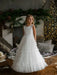 Teter Warm Celeste off-white communion dress worn by a girl standing indoors with festive decor.