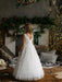 Teter Warm Celeste Off-White Communion Dress shown on a young girl standing in a decorated living room.