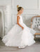 Teter Warm Cora off white communion dress on a young girl twirling in an elegant room.