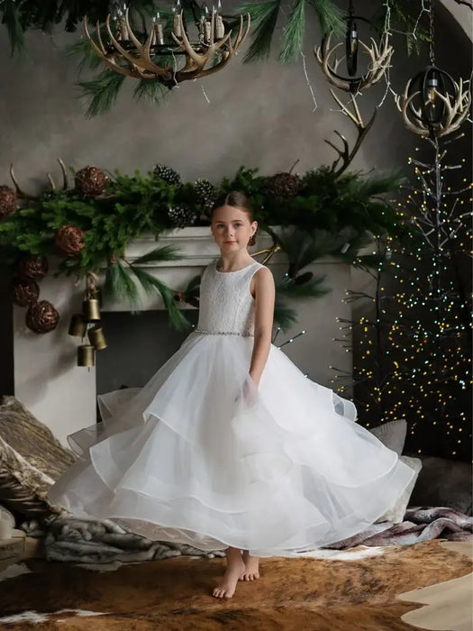 Teter Warm Cora Off White Communion Dress worn by a girl standing barefoot in a festive room.