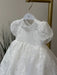 Teter Warm Dalia Floral Off-White Baptism Dress with puffy sleeves hanging on a white hanger.