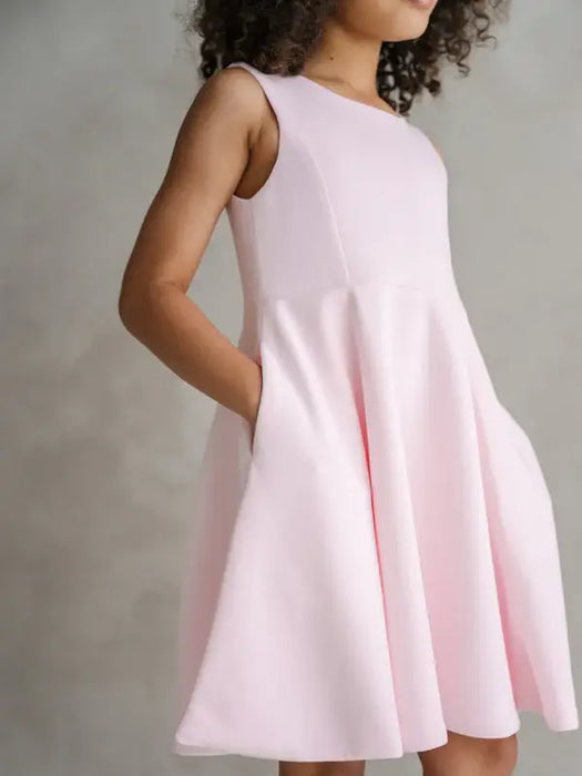 Teter Warm Diva bright pink party dress worn by a child, shown in a studio setting.