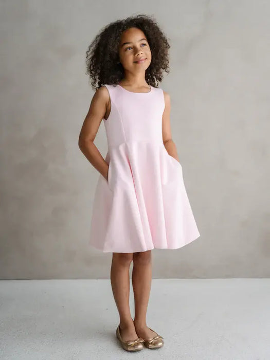 Teter Warm Diva bright pink party dress worn by a girl standing against a neutral background.