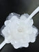 Teter Warm elegant white headband with layered flower and pearl accents on a dark background.