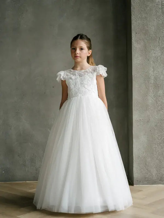 Emma Lace Communion Dress with floral bodice shown on a young girl standing indoors