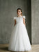 Emma Lace Communion Dress with floral bodice shown on a young girl standing indoors