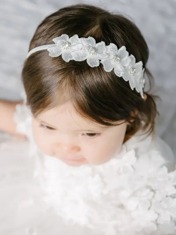 Teter warm floral headband with crystal detailing worn by a young girl in a white dress.