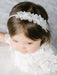 Teter warm floral headband with crystal detailing worn by a young girl in a white dress.