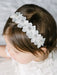 Teter Warm Floral Headband with Crystal shown on a young child with dark hair and white dress.