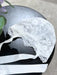 Teter Warm Floral Soft Lace Bonnet in white with floral lace detail displayed on a black tabletop.