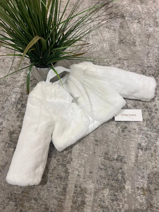 Teter Warm Gabriella girls long sleeve faux fur jacket displayed on a gray carpet beside a plant.