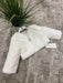 Teter Warm Gabriella girls long sleeve faux fur jacket displayed on a gray carpet beside a plant.