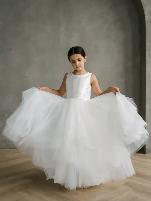 Teter Warm Girls Off-White Pearl Communion Dress displayed on a young girl standing indoors.