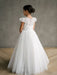 Gisele Lace Cap Sleeve Communion Dress shown on a girl standing with her back to the camera indoors.