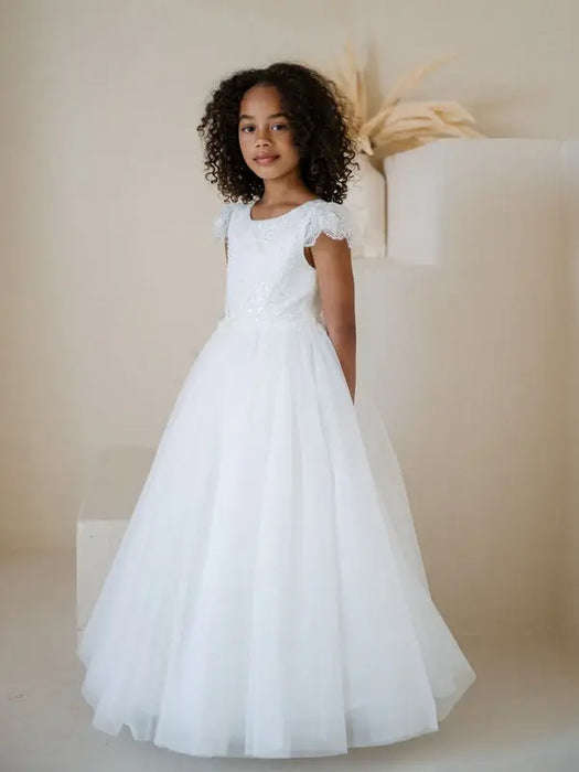 Heidi Sequin Bodice Communion Dress shown on a young girl standing in a neutral studio setting.