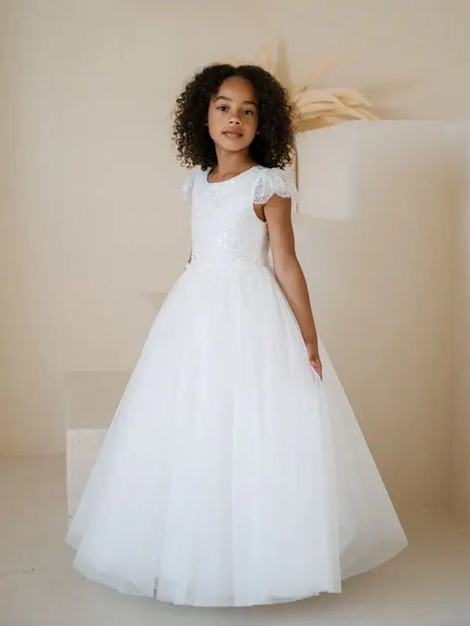 Heidi Sequin Bodice Communion Dress worn by a young girl standing in a neutral studio setting.
