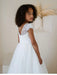 Heidi Sequin Bodice Comunion Dress worn by a girl, showing lace back and tulle skirt in a minimal room.