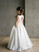 Teter Warm Isabella off-white satin communion dress shown on a young girl standing indoors
