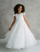 Teter Warm Lenni off-white communion dress shown on a smiling girl standing against a neutral background.