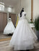 Teter Warm Marietta communion dress displayed on a mannequin in a boutique with mirrored walls.