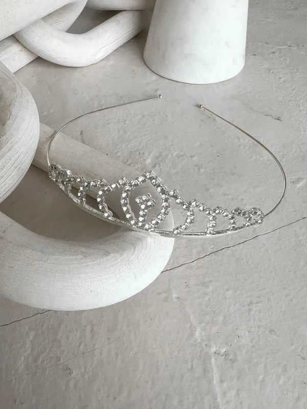 Teter Warm Millie rhinestone tiara displayed on a textured white stone surface.
