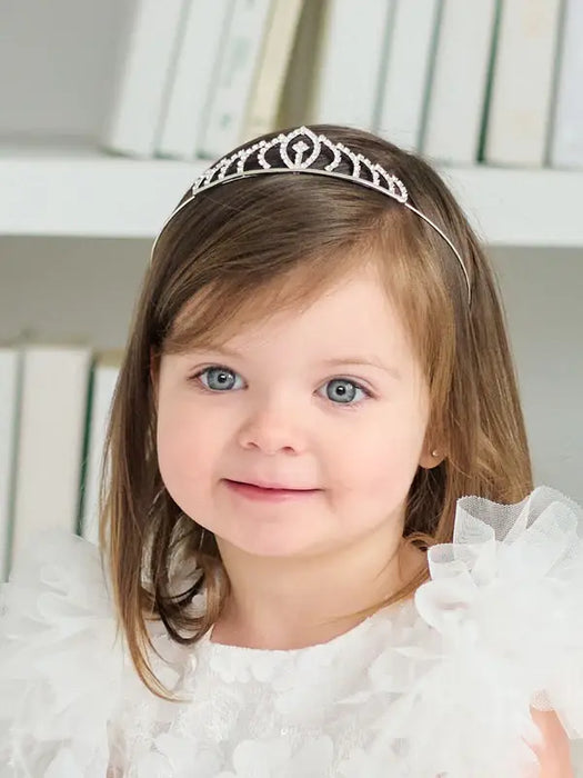 Teter Warm Millie Rhinestone Tiara worn by a smiling young girl in a white dress indoors