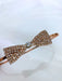 Teter Warm Polli Rose Gold Headband with crystal bow detail on a plain background.
