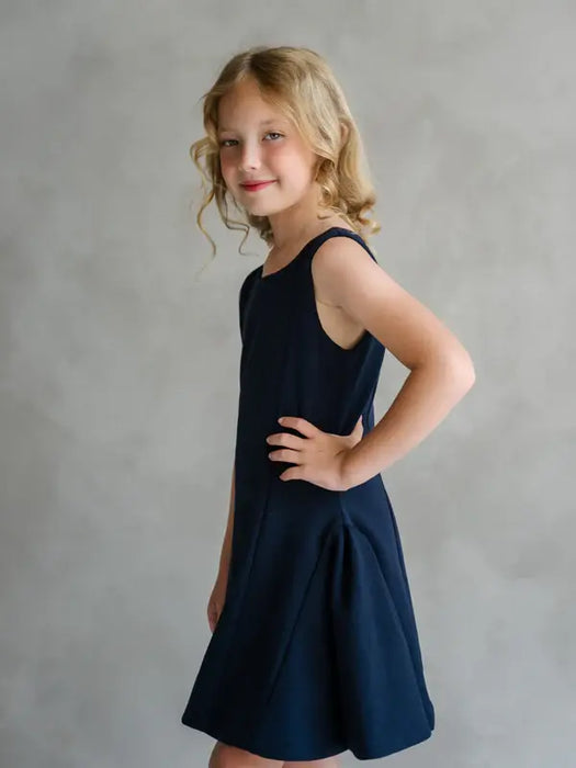 Teter Warm Rees sleeveless dark party dress worn by a child standing against a neutral background.