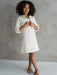 Teter Warm Sakura girls white tweed cropped jacket and dress modeled by a girl in a studio setting.
