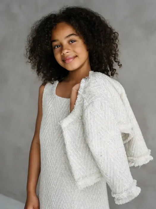Teter Warm Sakura Girls Tweed Cropped Jacket shown on a girl holding the jacket over her shoulder.
